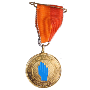 De officiële Kielegatse® medaille 1976 motto "getter un 'andje van!"