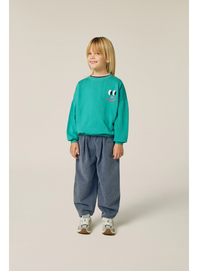 The campamento smiling face green sweatshirt
