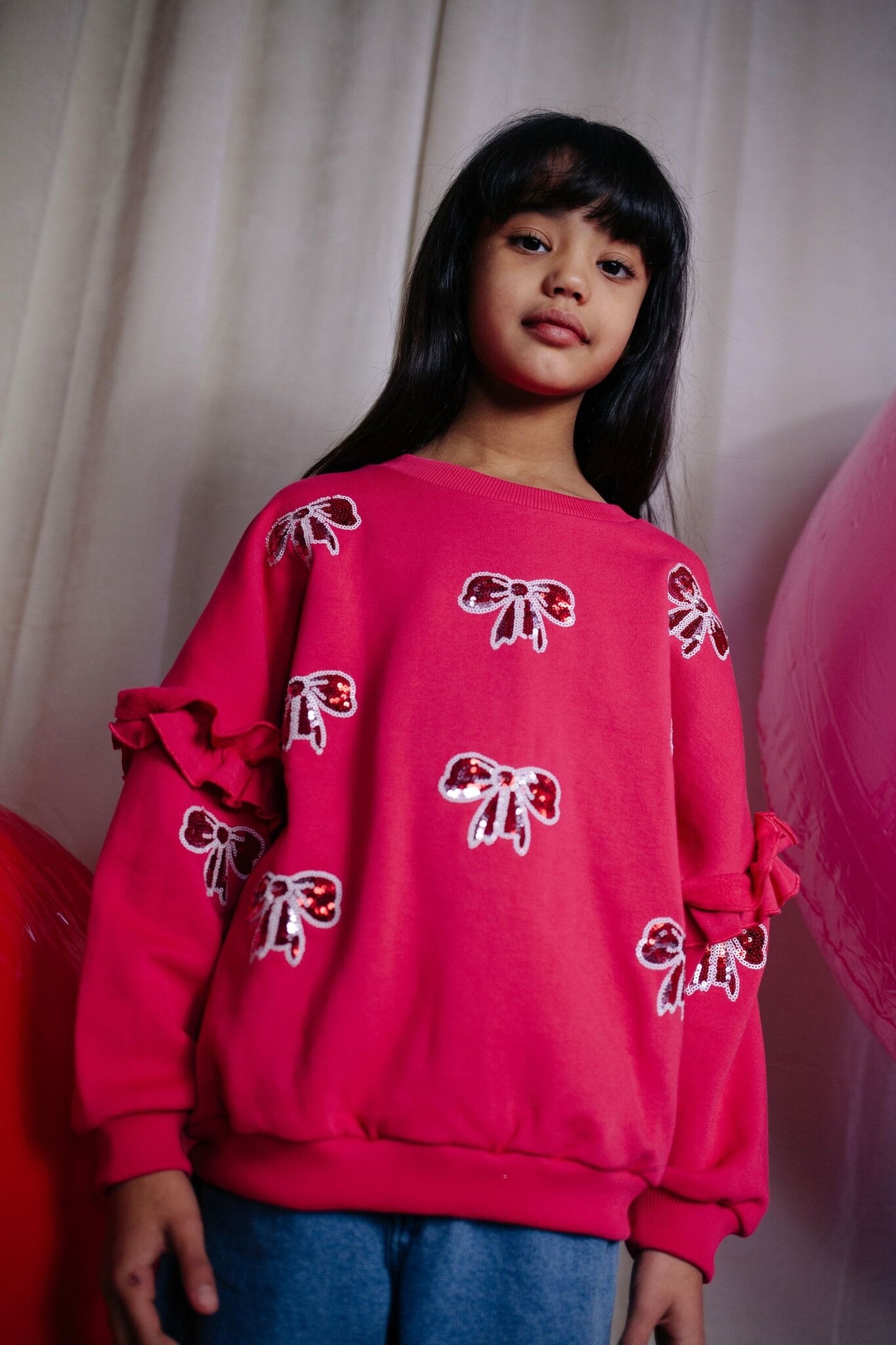 SHIMMER BOW SWEATER LOVE POTION