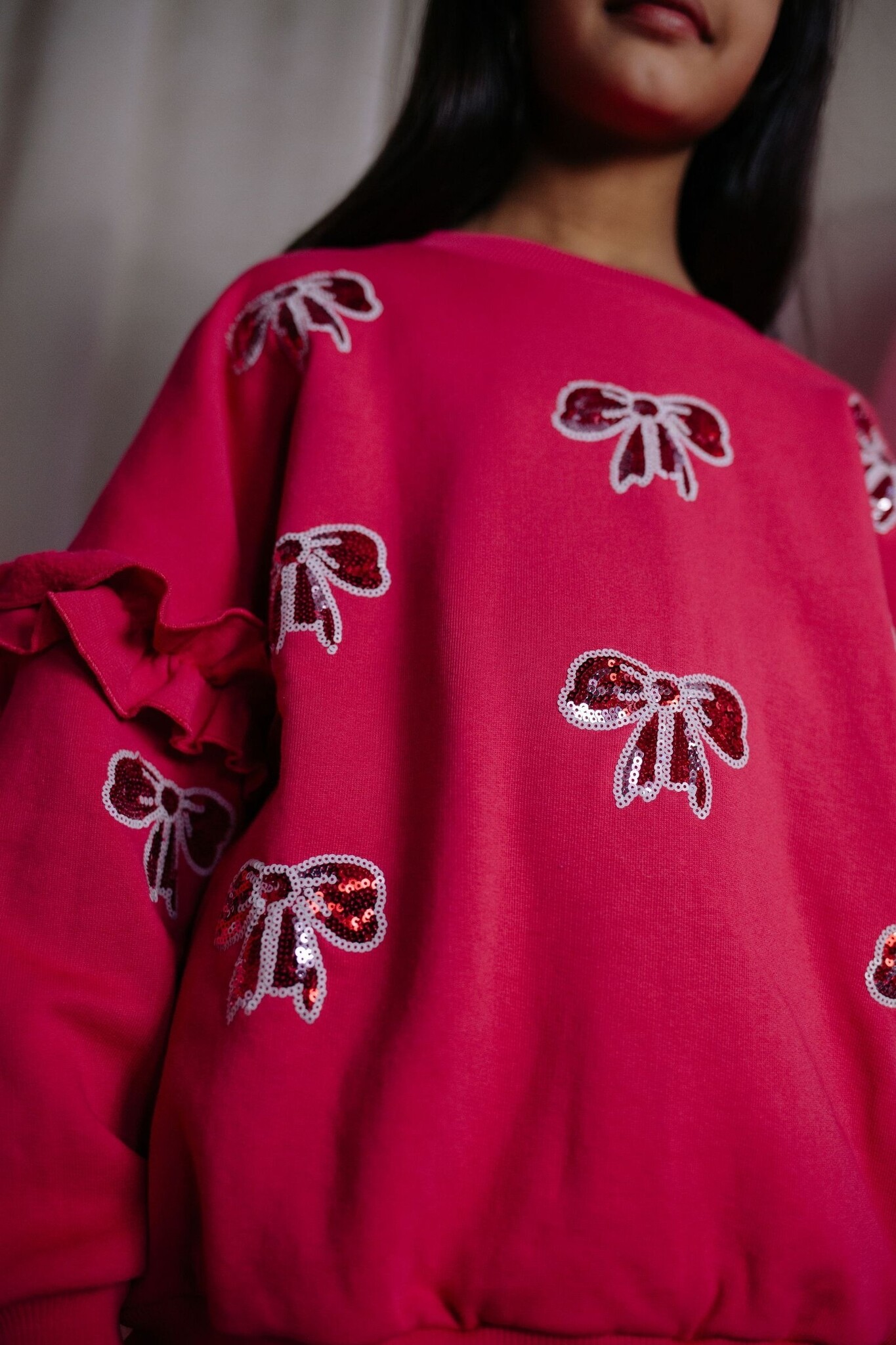 SHIMMER BOW SWEATER LOVE POTION