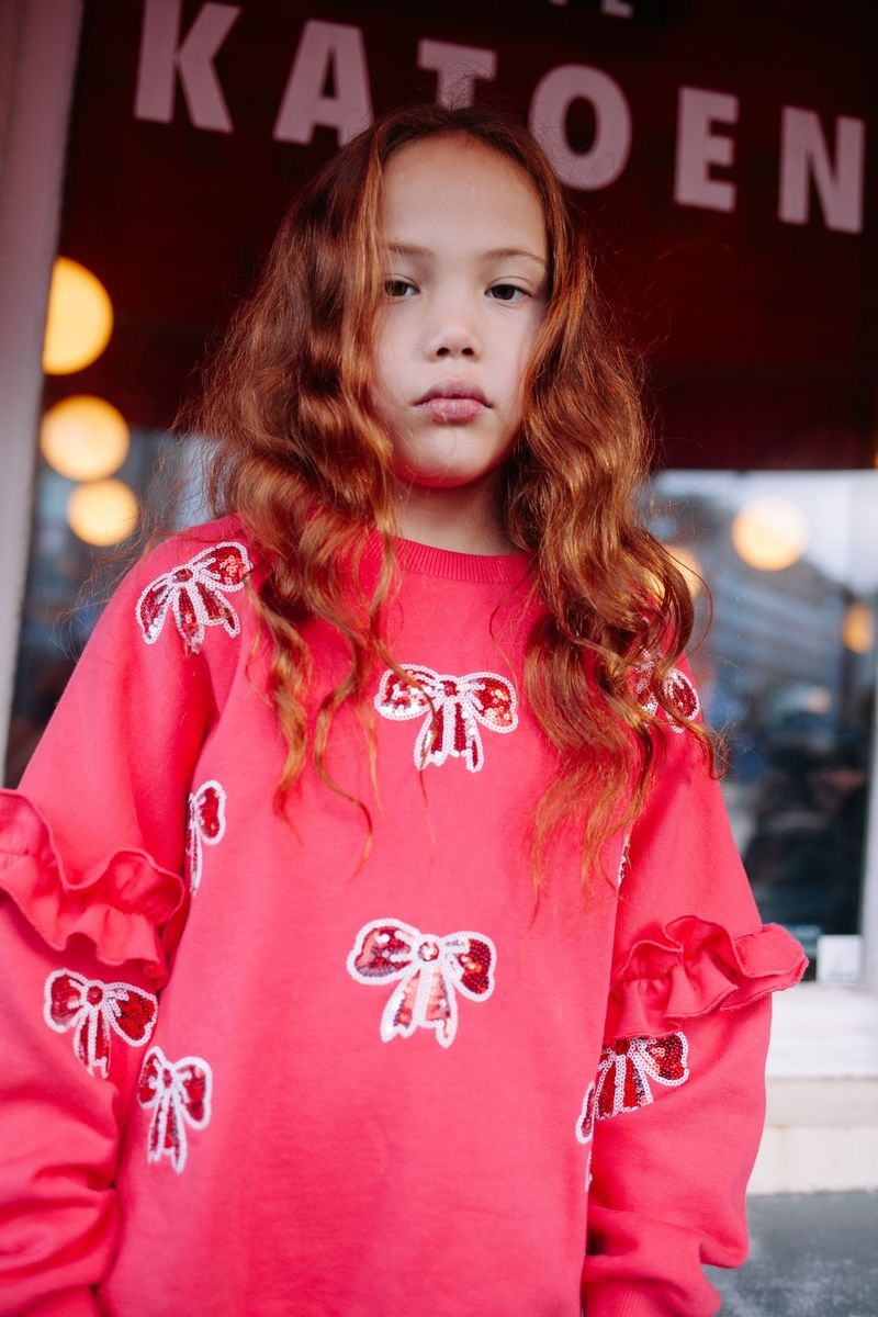 SHIMMER BOW SWEATER LOVE POTION