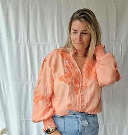 Coral blouse broderie