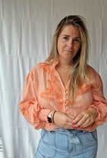 Coral blouse broderie