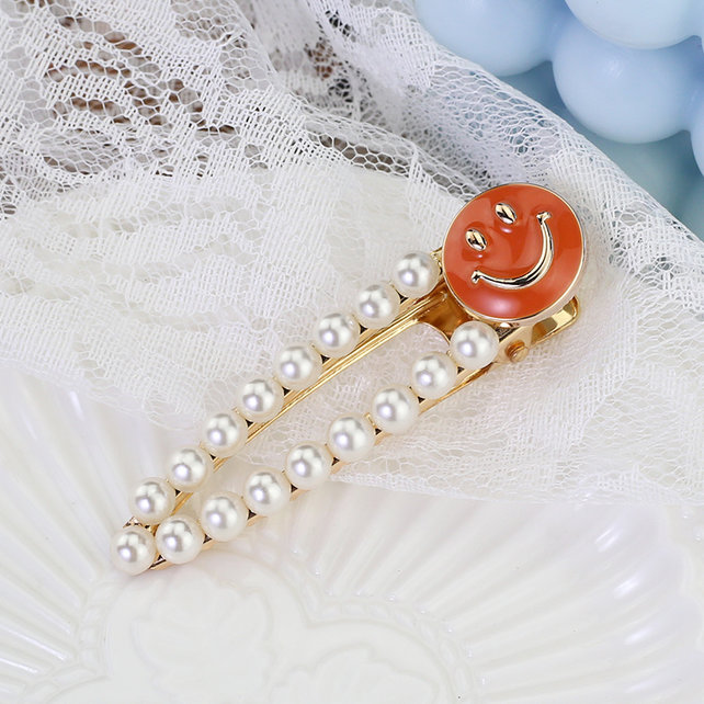 Haarknip offwhite smiley oranje