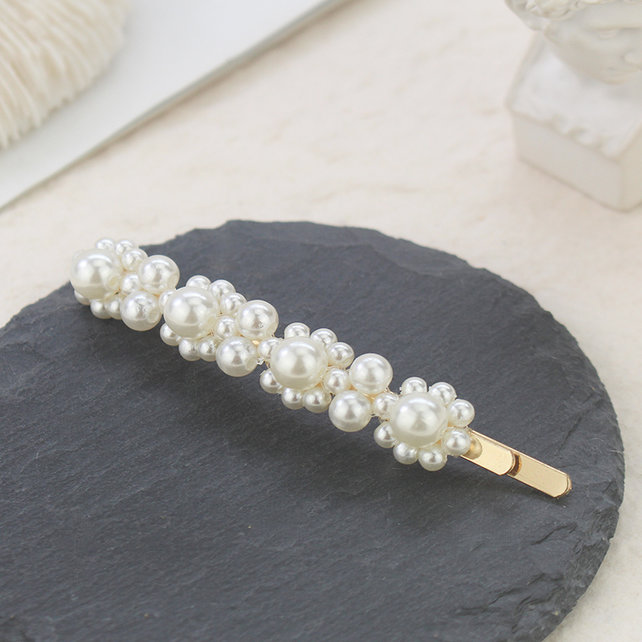 Haarspeld / haarschuif met vier parelbloemetjes