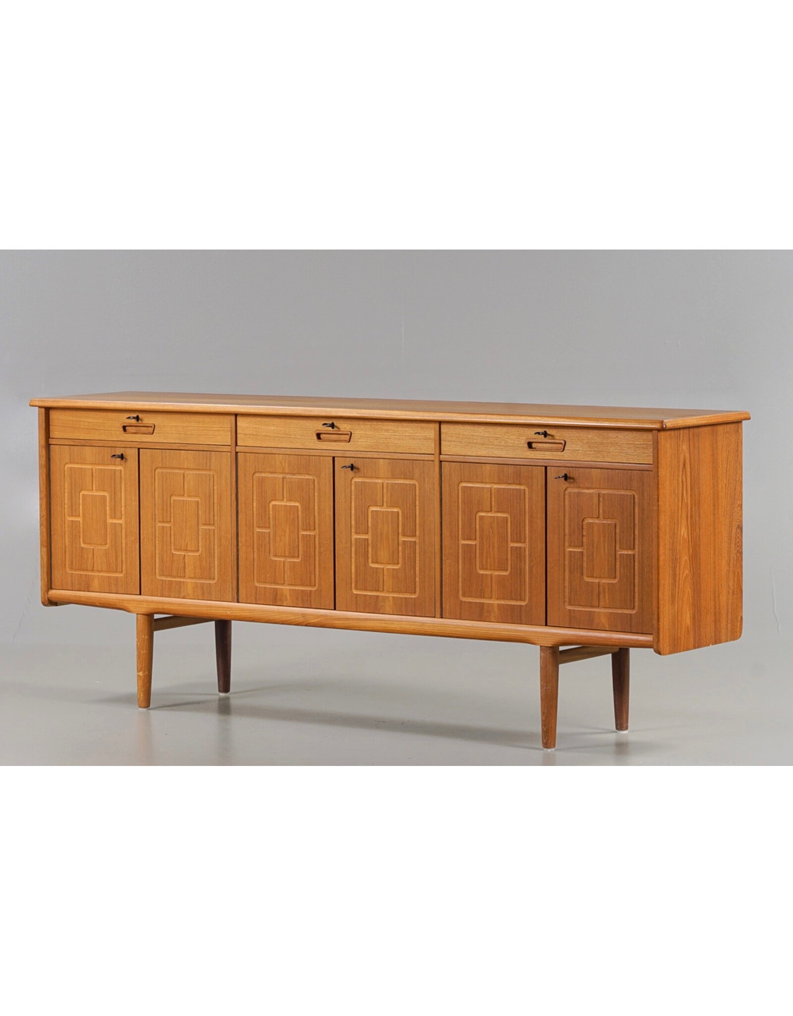1960'S TEAK SIDEBOARD WITH CARVED RELIEF DOORS