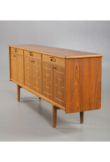 1960'S TEAK SIDEBOARD WITH CARVED RELIEF DOORS