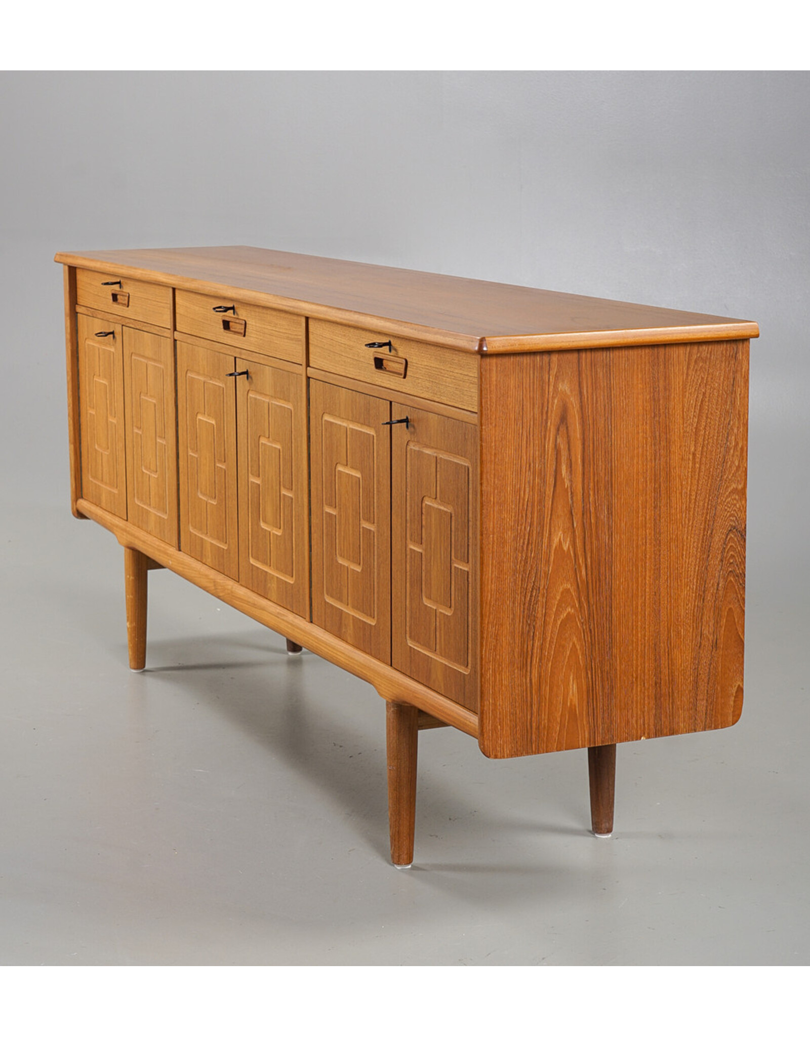 1960'S TEAK SIDEBOARD WITH CARVED RELIEF DOORS