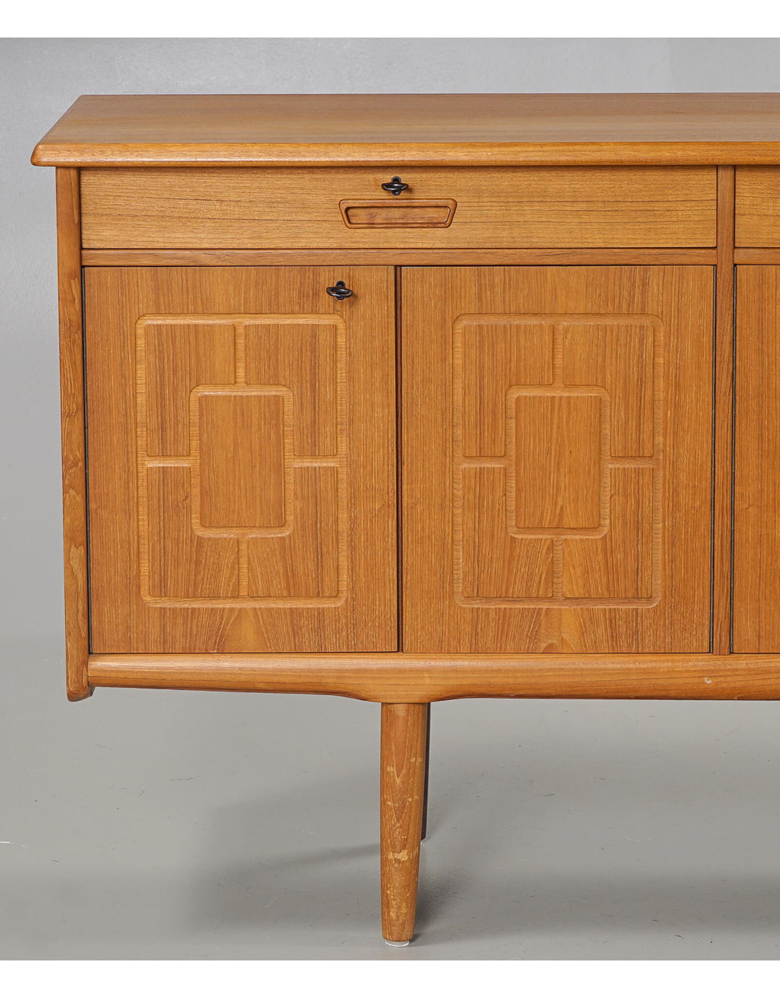 1960'S TEAK SIDEBOARD WITH CARVED RELIEF DOORS