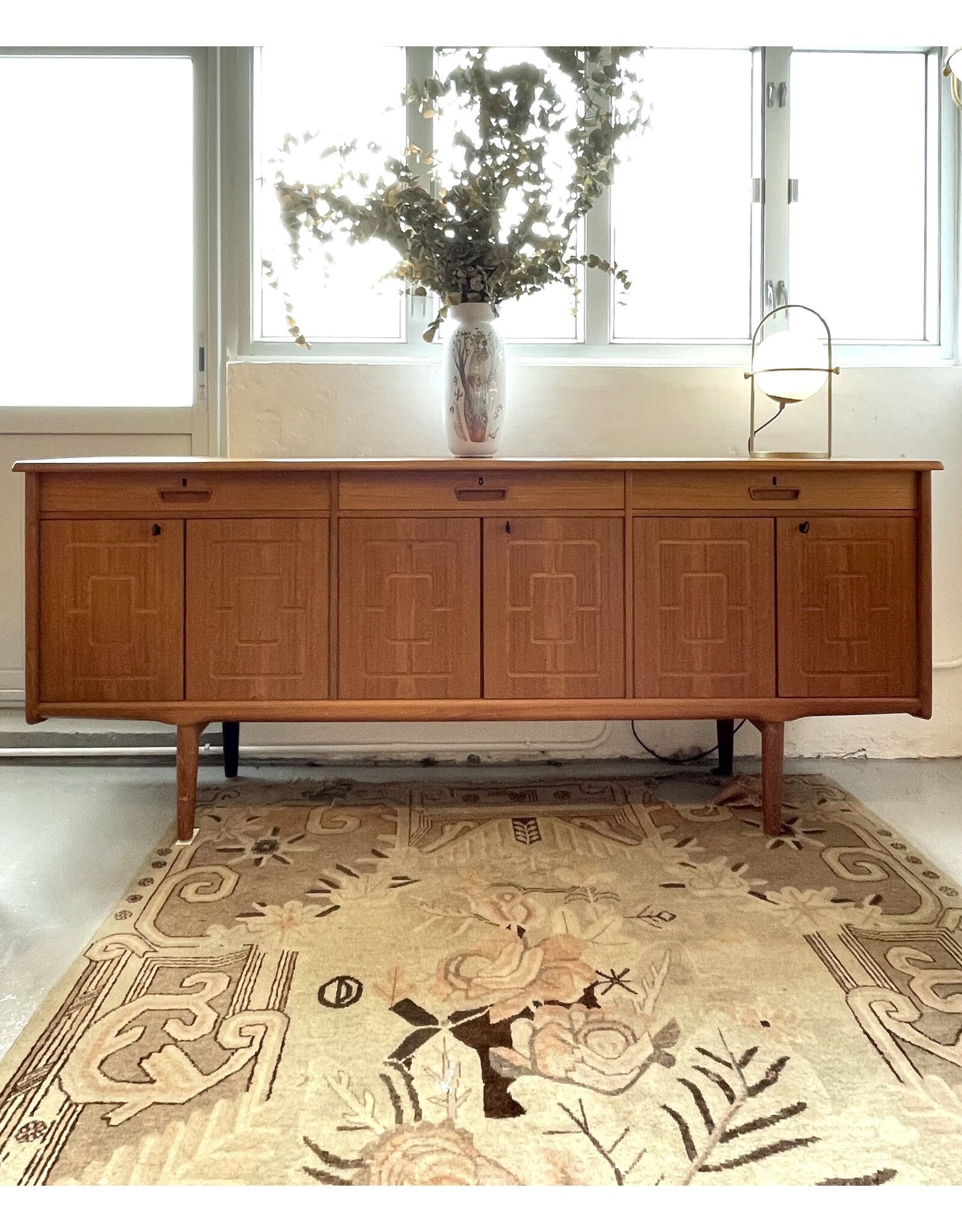 1960'S TEAK SIDEBOARD WITH CARVED RELIEF DOORS