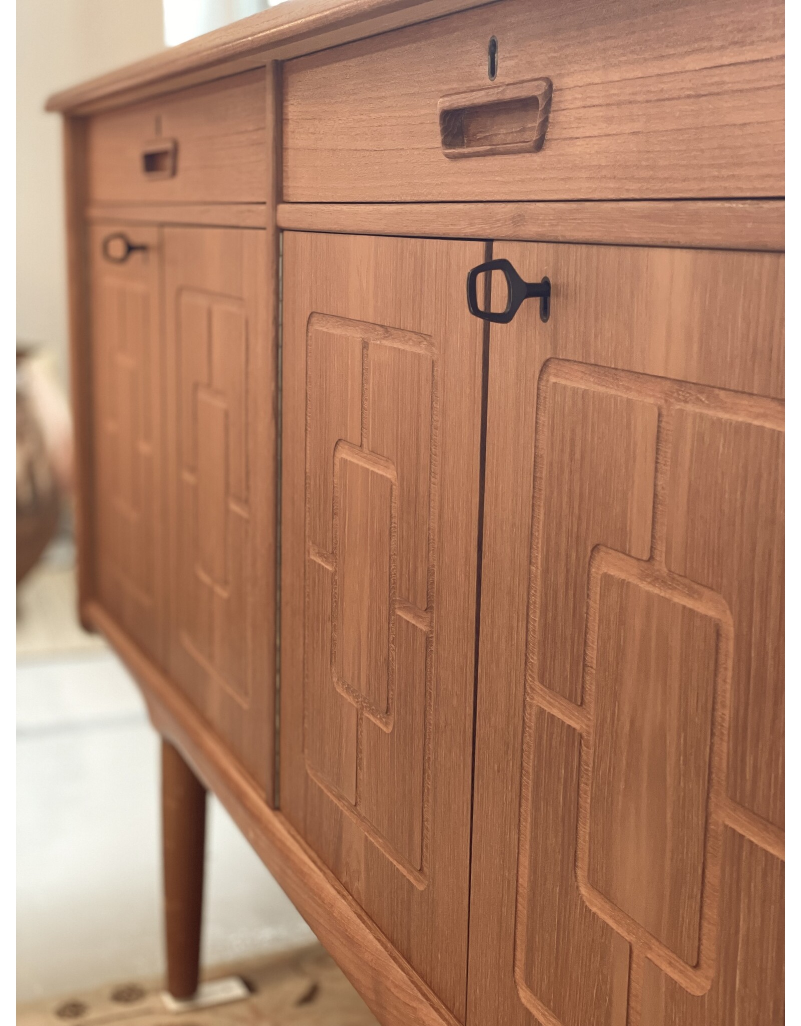 1960'S TEAK SIDEBOARD WITH CARVED RELIEF DOORS
