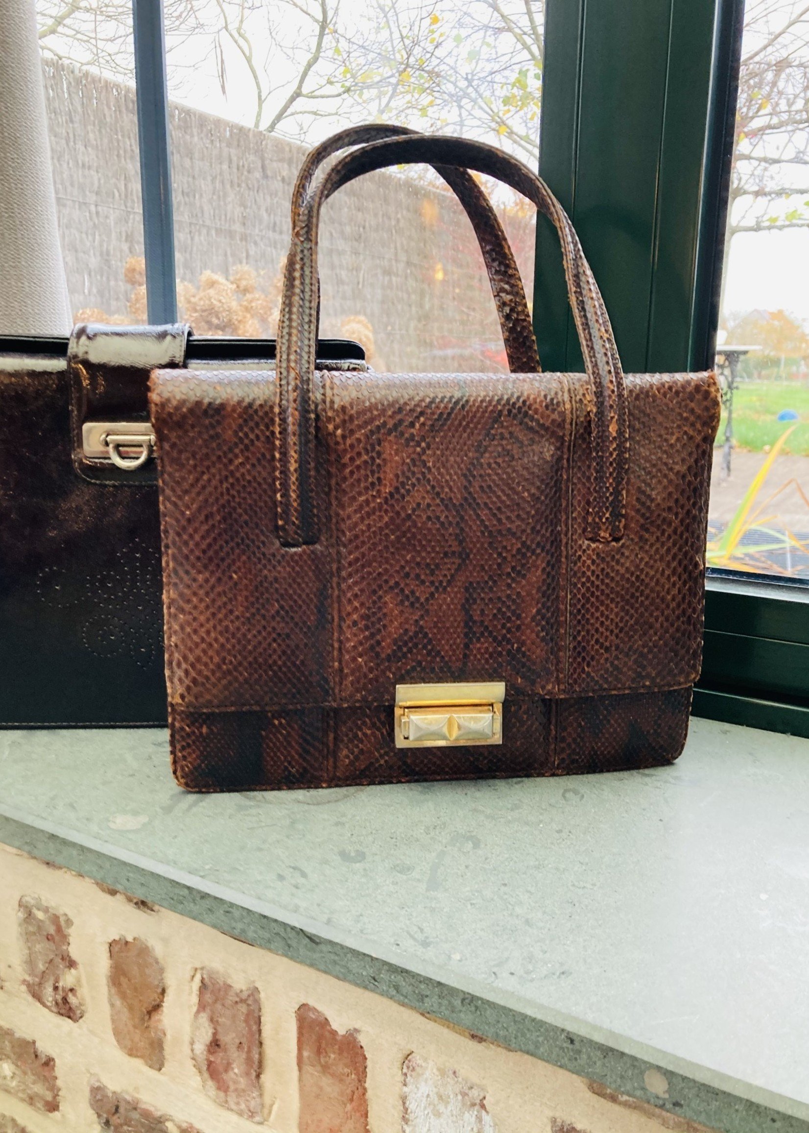 Brown leather (python) handbag with brass and leather closure