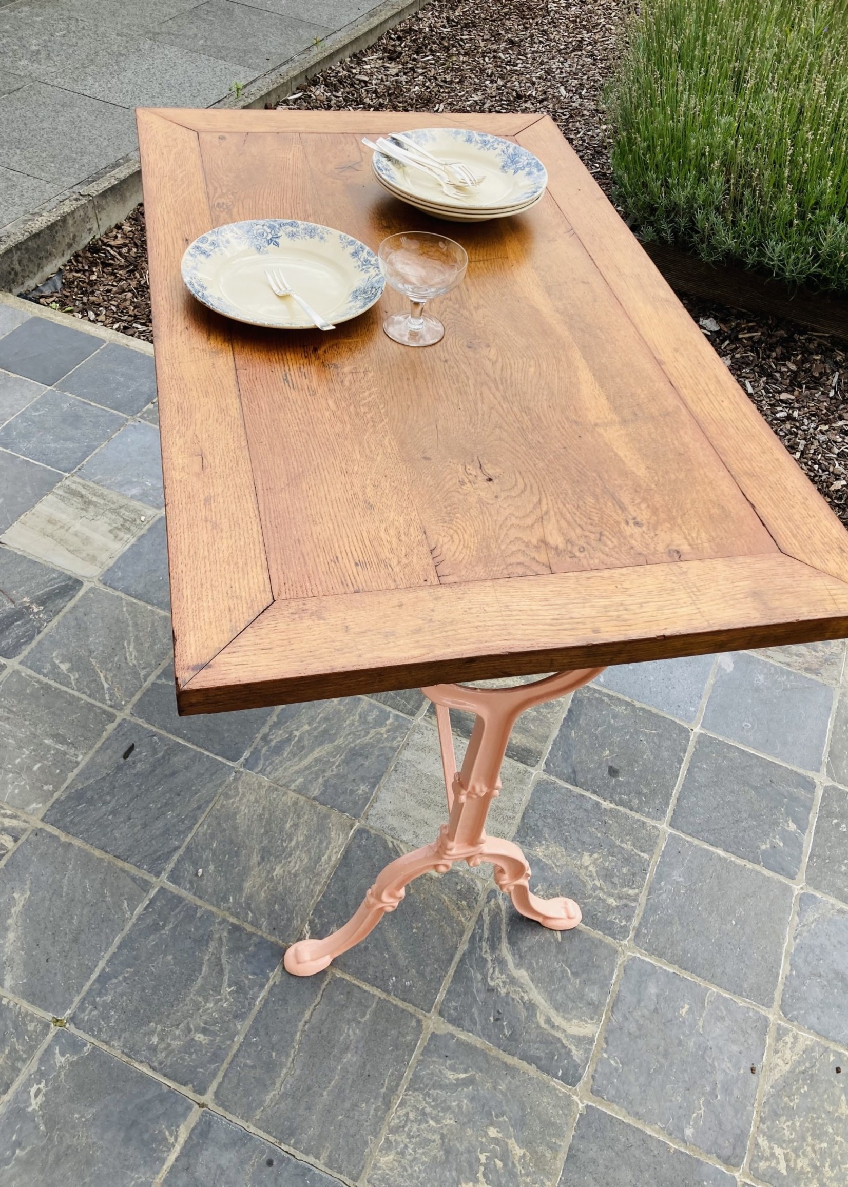 Rectangular table with wooden table top and pink painted cast iron base, bistrot style