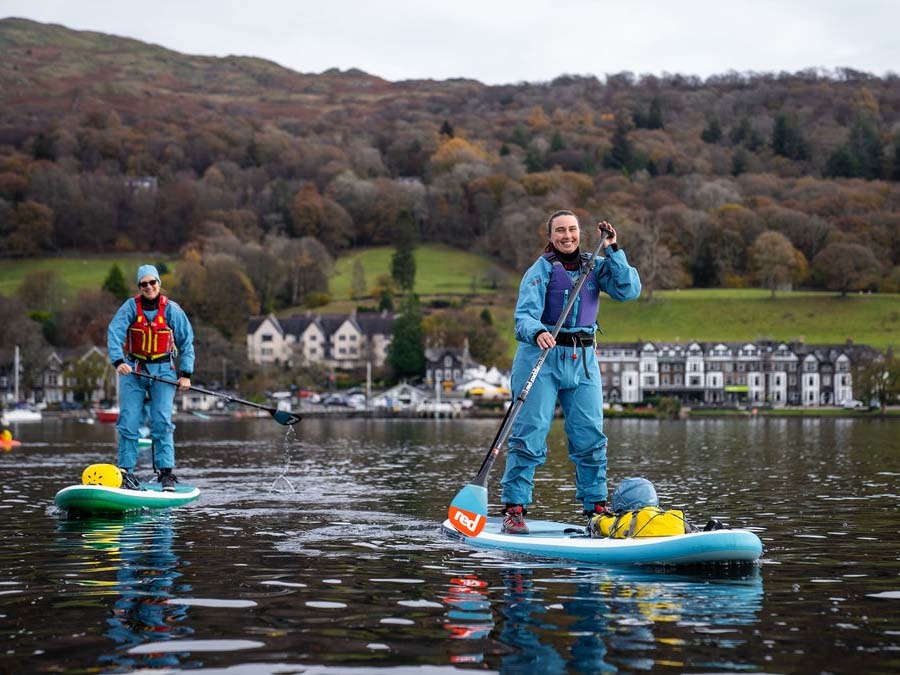 Two women paddleboarding in the Lake District