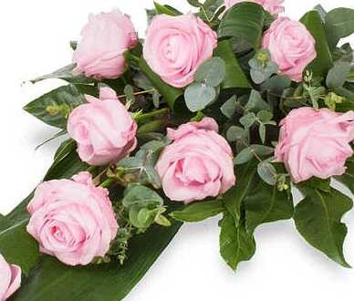 Roze rouwbloemen in een rouwbloemstuk