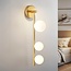 3-light wall lamp Taj with white globes - gold