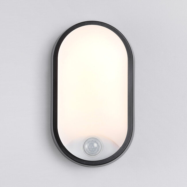 Oval outdoor wall light with sensor and three colour settings