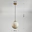 1-light pendant light Tessra with marble-effect glass and brass gold
