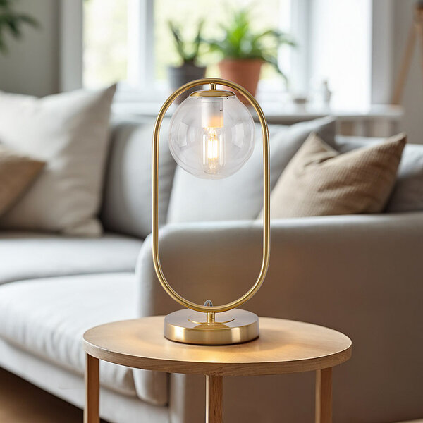 Złota lampka stołowa design z przezroczystego szkła - George