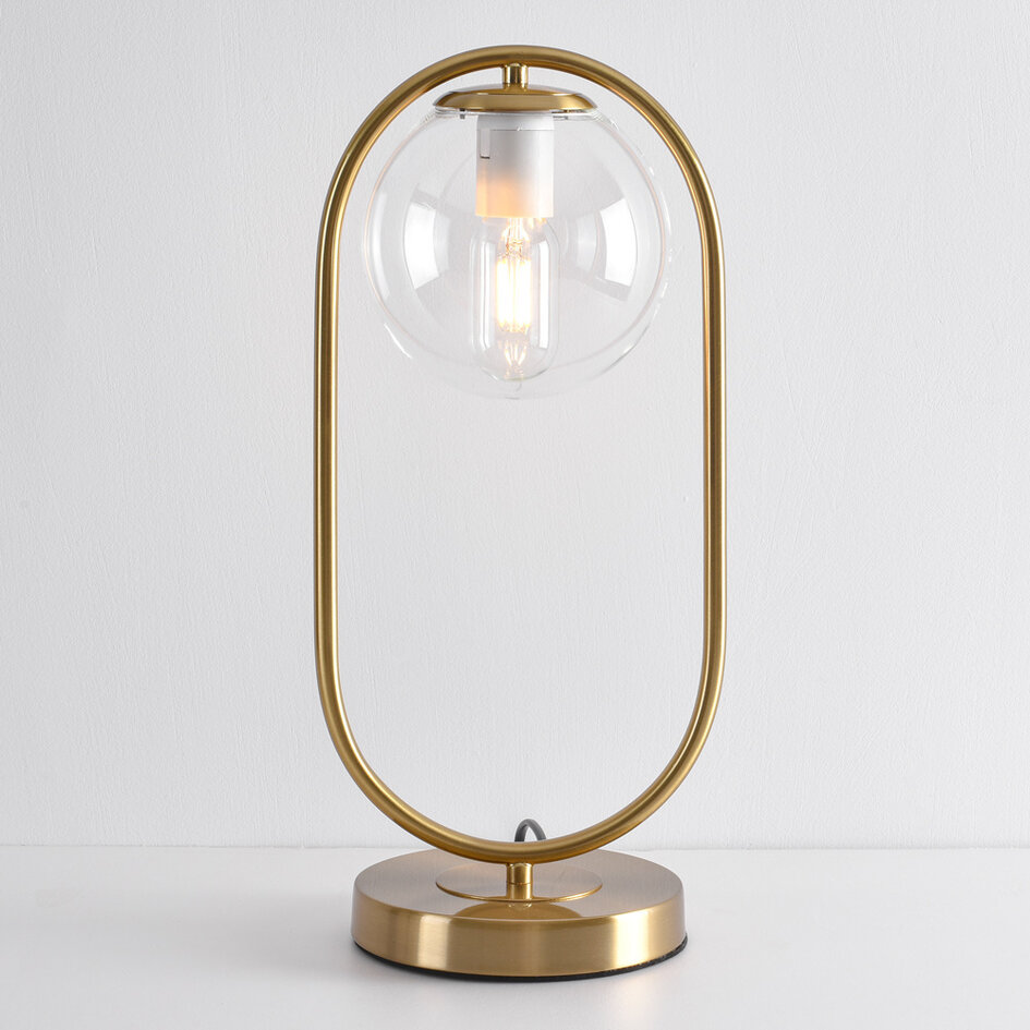 Złota lampka stołowa design z przezroczystego szkła - George