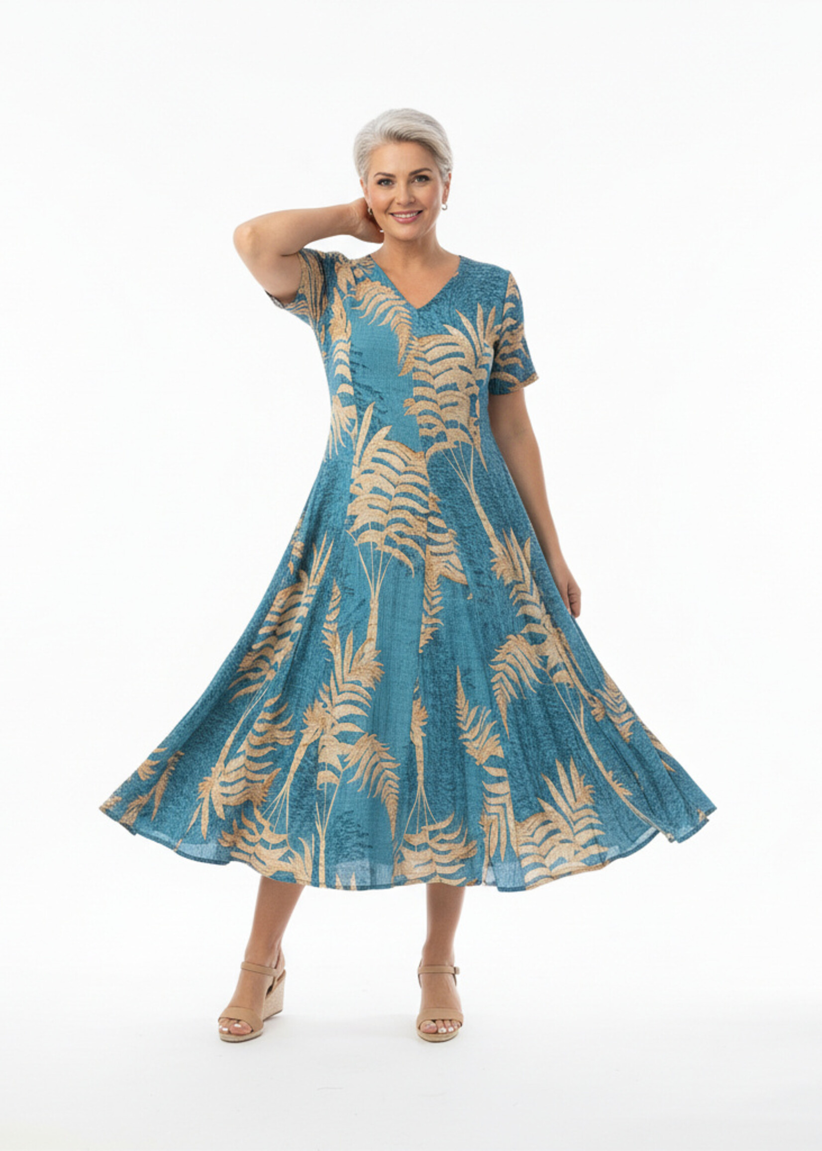 Orientique Natuurlijk, hier is de producttekst voor de Orientique Jurk Ponta Verde Godet (40203).  Op basis van de foto zie ik een prachtige, diepe blauw-groene (petrol/teal) basiskleur met een beige/goudkleurige palmbladerenprint. Het is duidelijk weer het geliefde