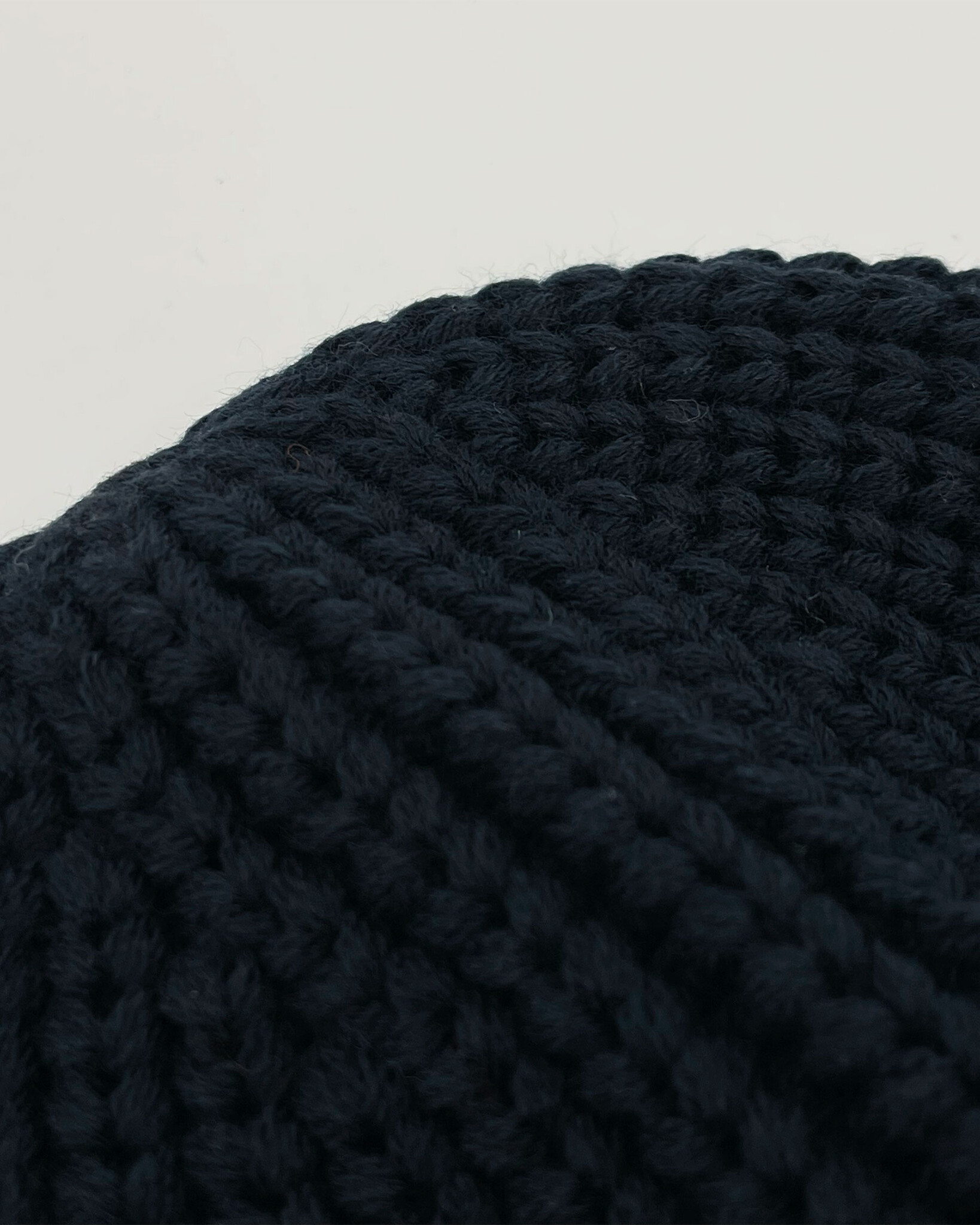 Heavy knitted beanie made from sustainable Polylana® fiber mix with trademark logo