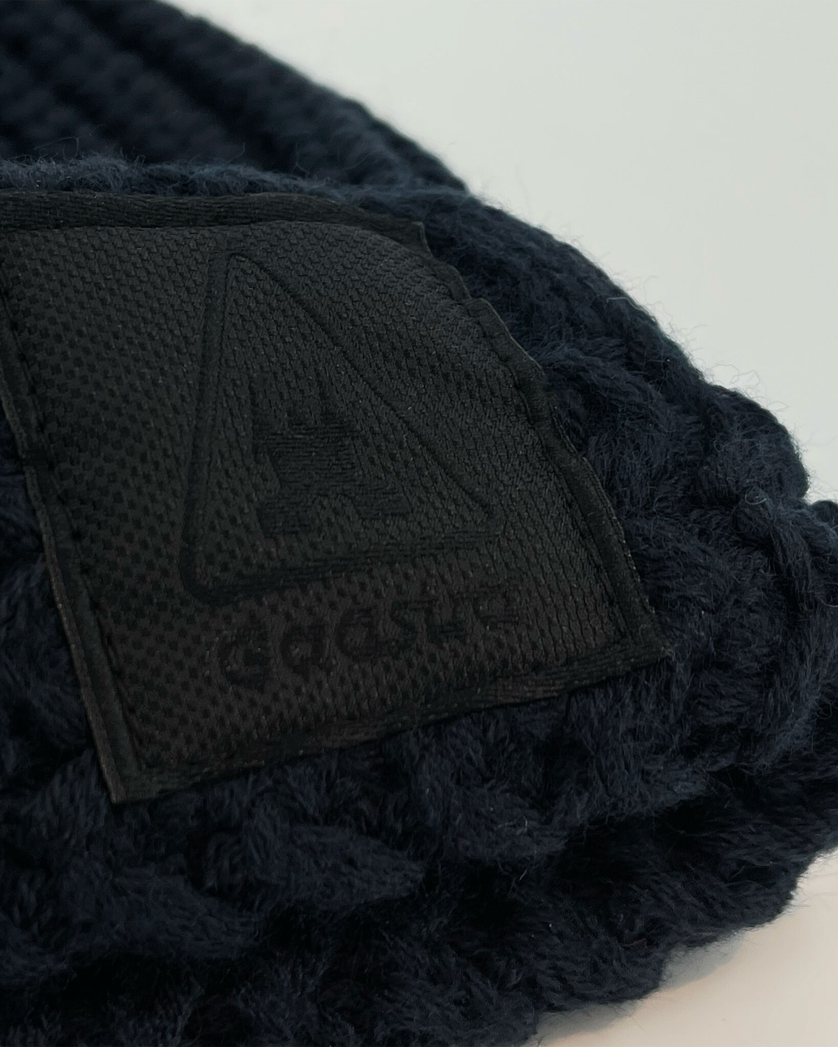 Heavy knitted beanie made from sustainable Polylana® fiber mix with trademark logo