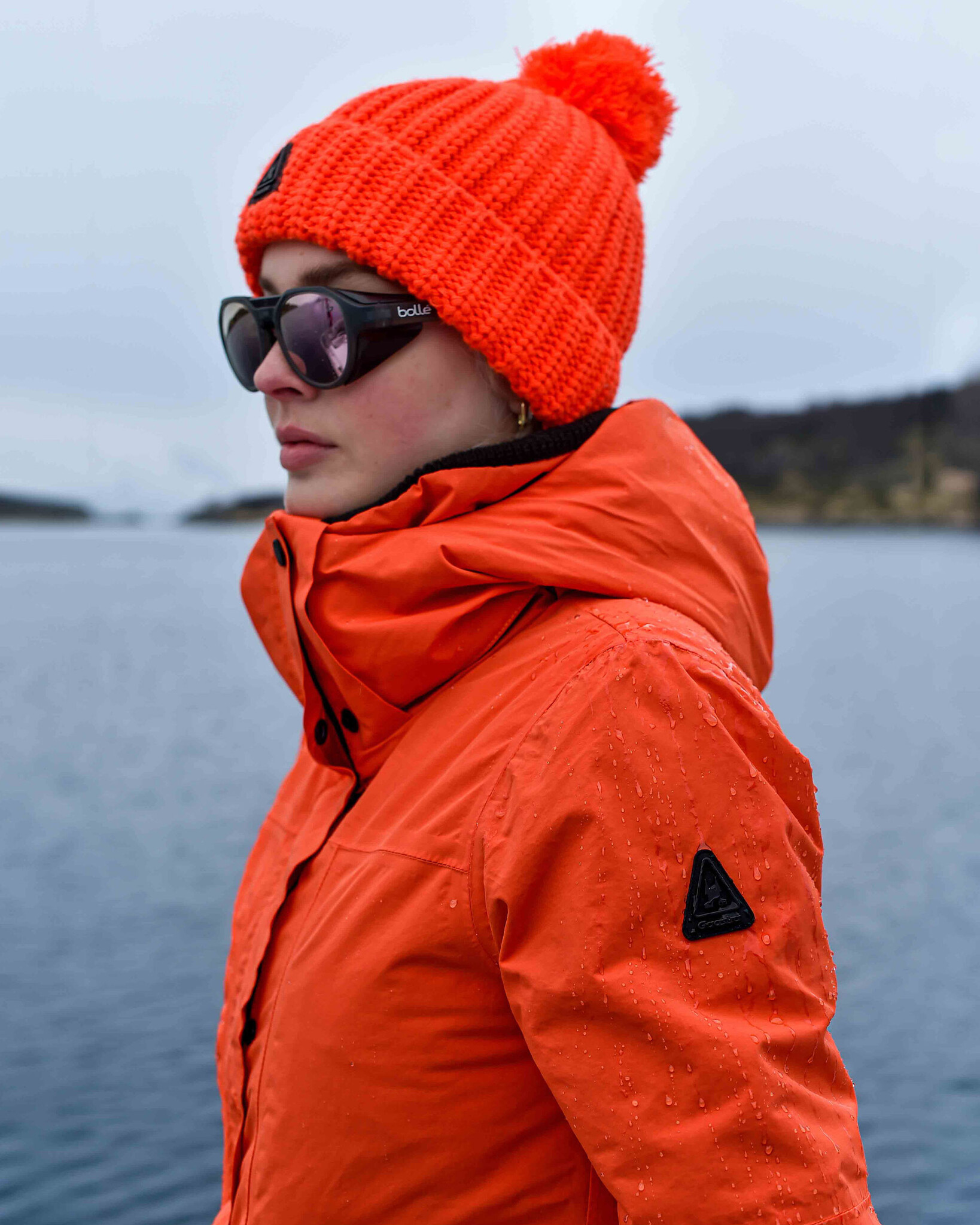 Waterproof Mid Length Jacket  developed with a technical 2-layer fabric, detachable hood and REPREVE® padding