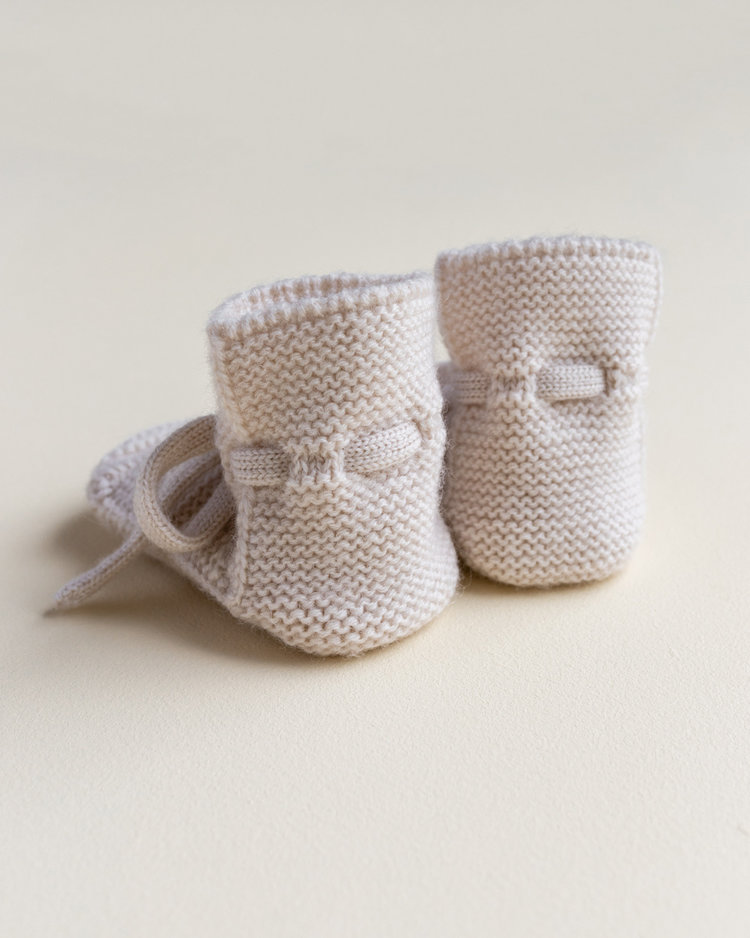 Hvid babyslofjes van merinowol crème
