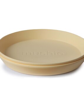 Mushie Set of 2 round plates  - pale daffodil