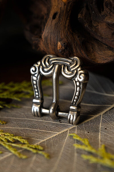 Viking buckle gripping hands - Celtic Webmerchant