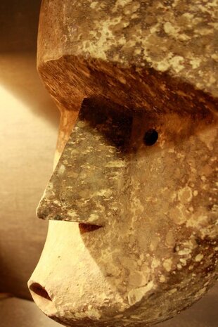 Houten masker in sobere tinten op standaard Houten masker in sobere tinten op standaard