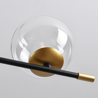 Pendellampa Nisha med sex lampor i transparent glas - svart och guld