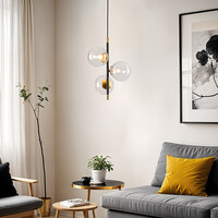 Pendellampa Nisrin med tre lampor i transparent glas - svart och guld