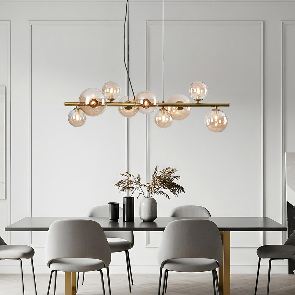 Pendellampa Ennea med nio lampor - guld och amberfärgat glas