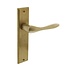 Deurklink Banaan met schild blind messing getrommeld Deurklink Banaan met schild blind messing getrommeld
