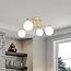 4-light ceiling light Nymo - gold with milk-white glass globes
