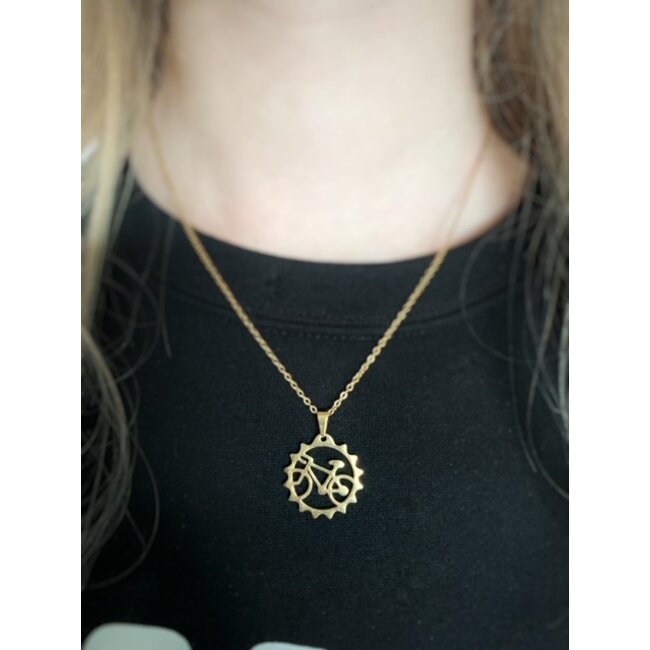 gold colored necklace with bicycle hanger