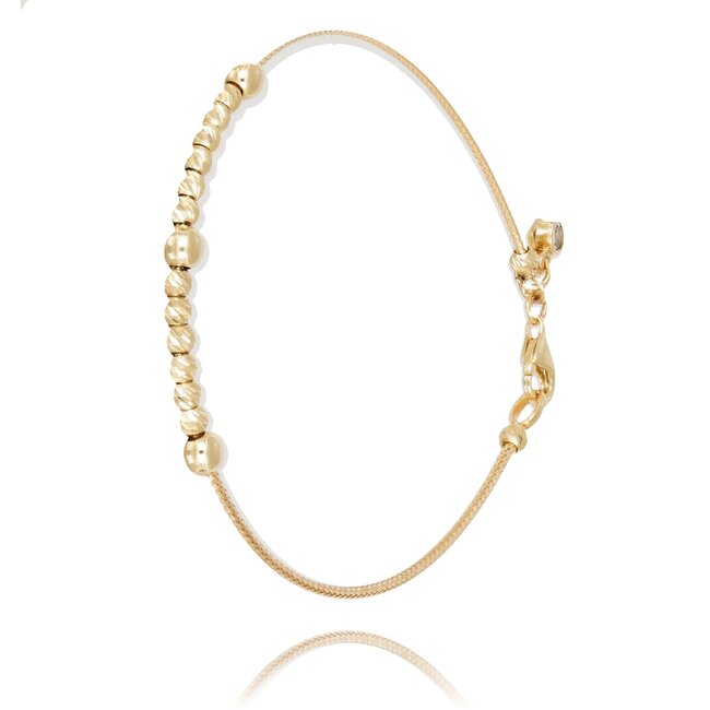 Elegante gouden armband met glanzende dorika balletjes