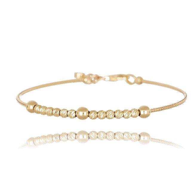 Elegante gouden armband met glanzende dorika balletjes