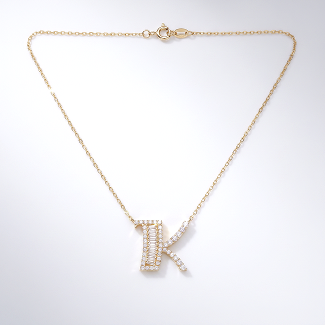 Gouden letter K ketting met baguette
