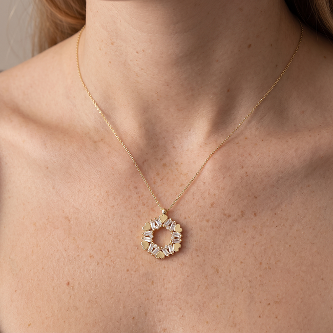 Gouden collier met hartjes en baguette zirkonia