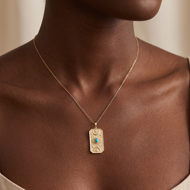 Gouden collier met turquoise steen en oogmotief