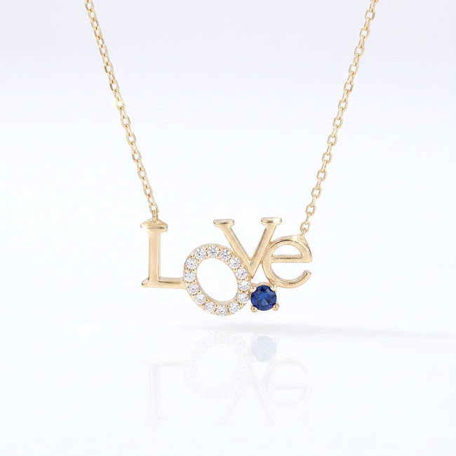 Gouden love collier met zirkonia en blauwe steen
