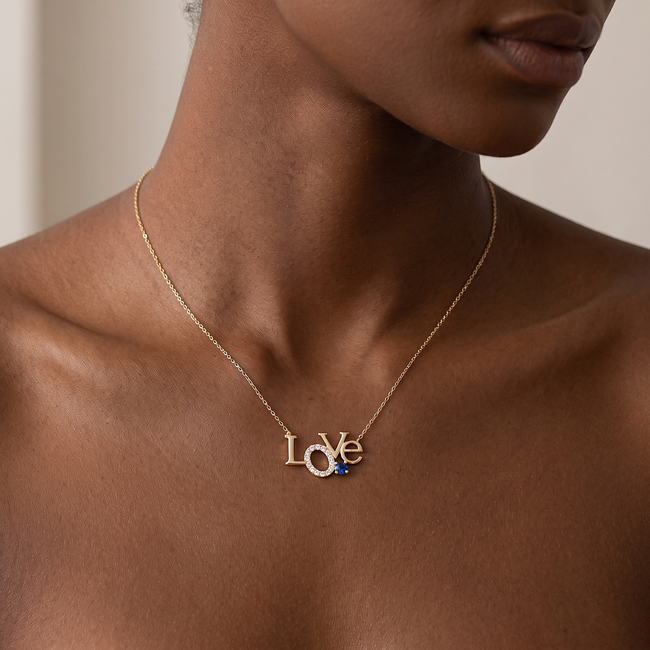 Gouden love collier met zirkonia en blauwe steen