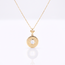 Gouden vollier met ananas hanger en witte steen