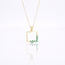 Gouden collier met groene baguette hanger
