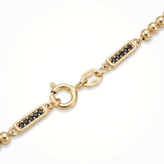 Gouden bolletjesarmband zwarte zirkonia