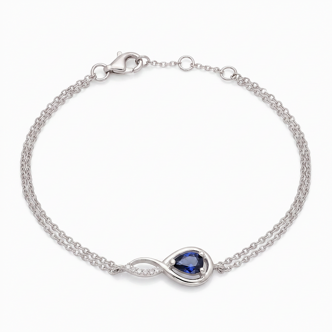 Witgouden infinity armband met saffier en diamant