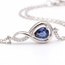 Witgouden infinity armband met saffier en diamant